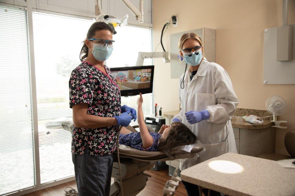 Doctor Mack with dental assistant and patient